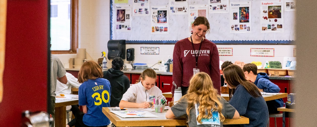 An Eagle view teacher smiles as she interacts with her students in class.